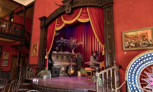 Claude Hopper playing music on the piano at the Buckaroo Revue live entertainment show